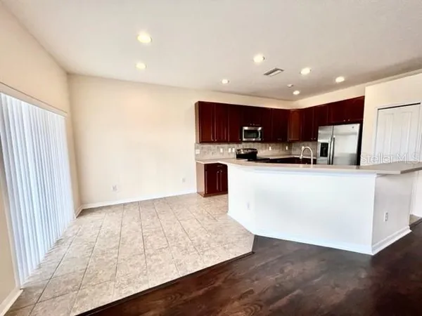 a kitchen with stainless steel appliances granite countertop a sink refrigerator and microwave