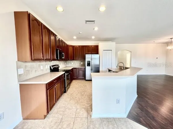 a kitchen with a sink a stove and a window