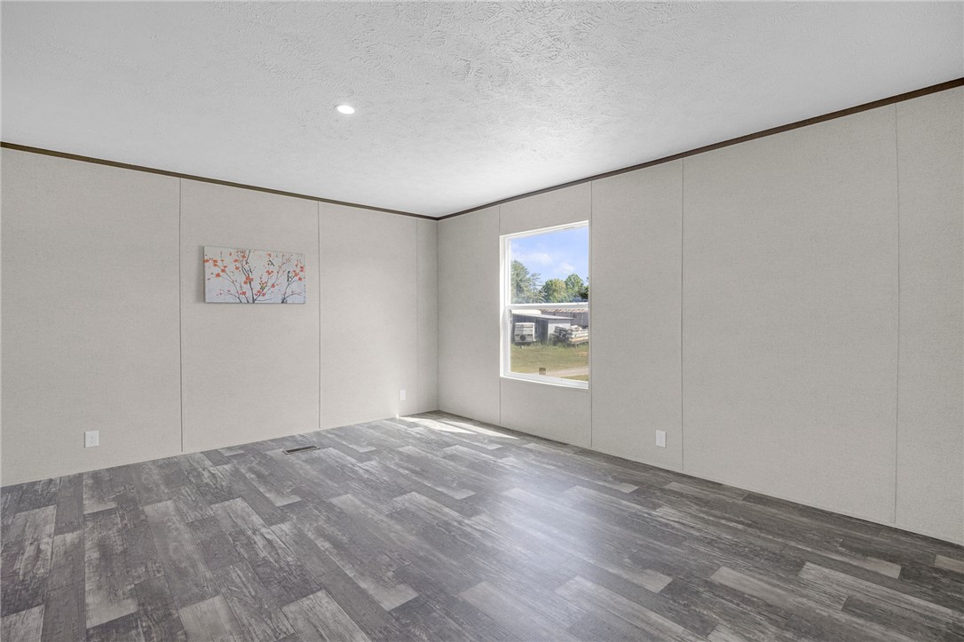 375 Griggs Road Six Mile, SC 29682 - Photo 17 of 36 This bright, airy room features durable flooring and ample natural light, creating a versatile living space.