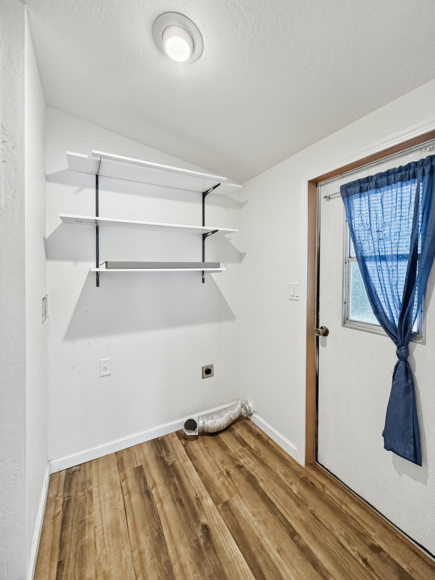 8401 Old Stage Road, Unit 16 Central Point, OR 97502 - Photo 20 of 23 a view of a room with wooden floor and white walls
