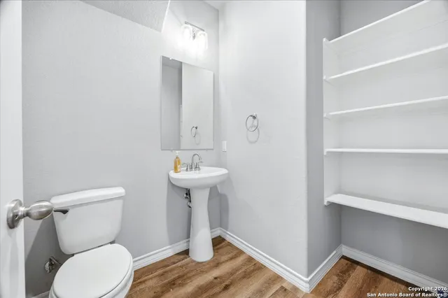 a bathroom with a toilet sink and mirror