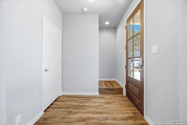 a view of an empty room and wooden floor
