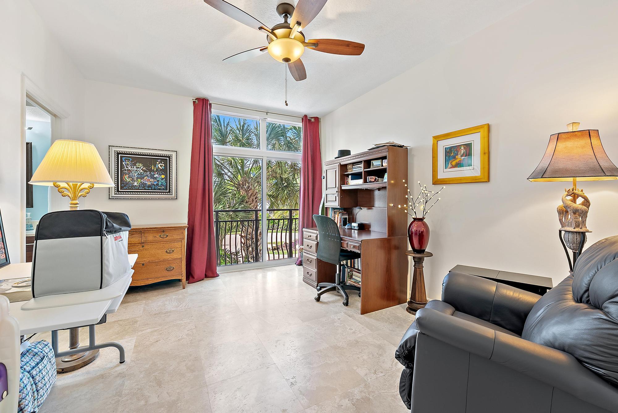 314 Inlet Way, Unit 103 Palm Beach Shores, FL 33404 - Photo 14 of 20 a living room with furniture and a lamp