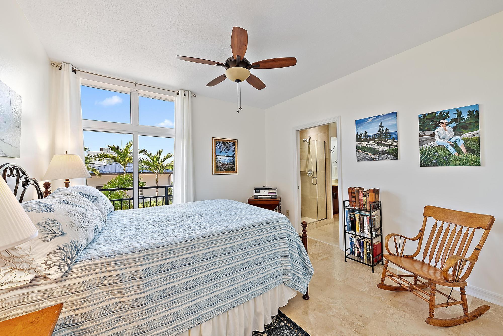 314 Inlet Way, Unit 103 Palm Beach Shores, FL 33404 - Photo 15 of 20 a bedroom with a bed and a chandelier