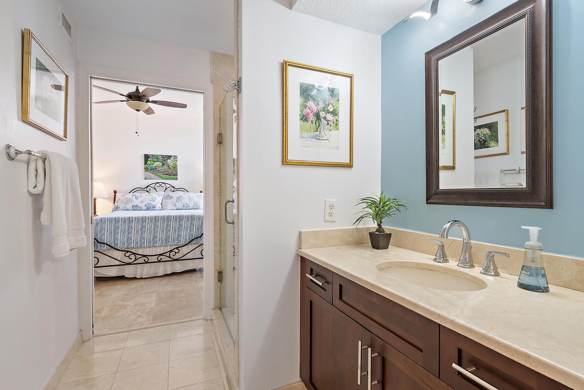 314 Inlet Way, Unit 103 Palm Beach Shores, FL 33404 - Photo 16 of 20 a en suite bathroom with a double vanity sink and a mirror