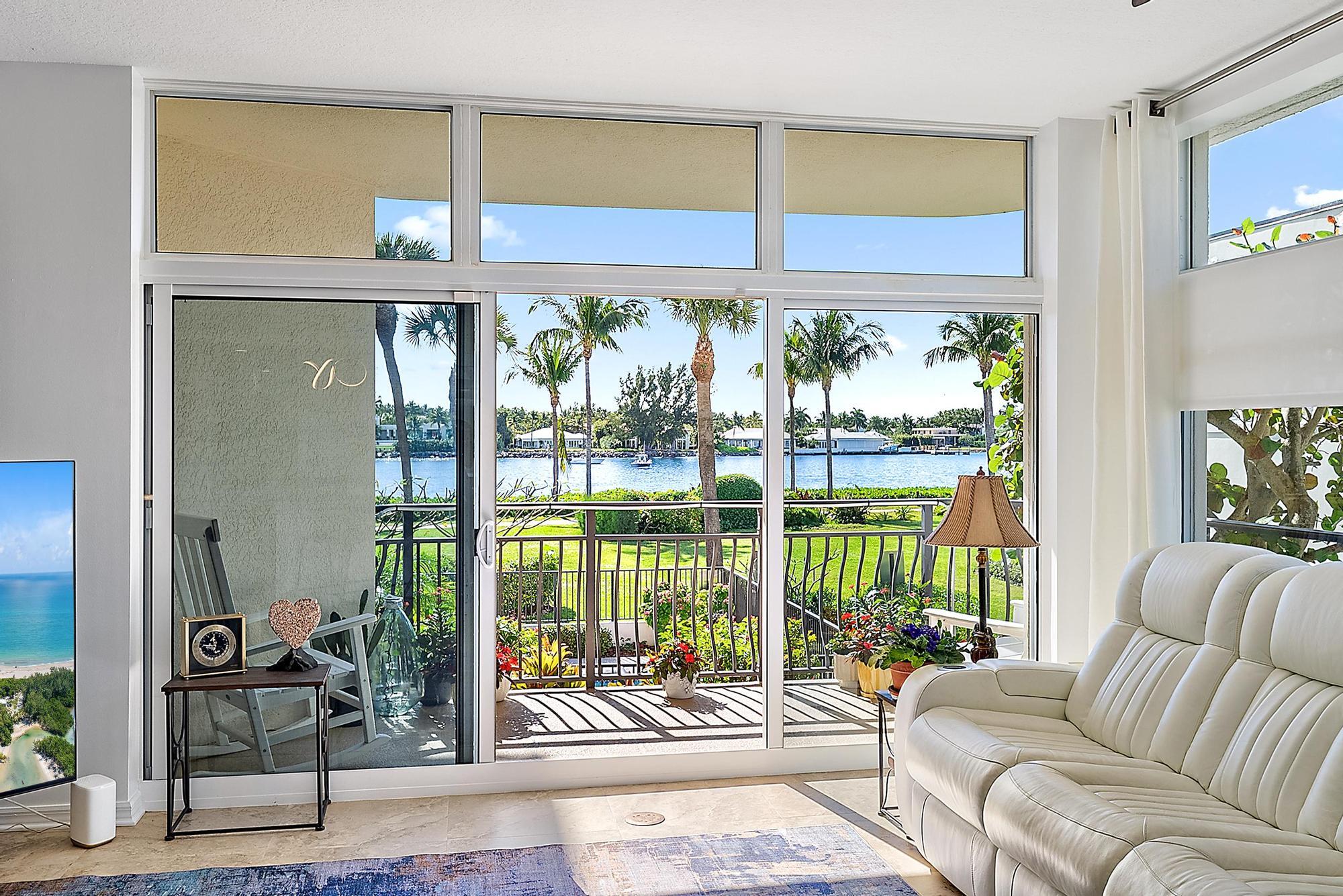 314 Inlet Way, Unit 103 Palm Beach Shores, FL 33404 - Photo 7 of 20 a living room with furniture tv and floor to ceiling window