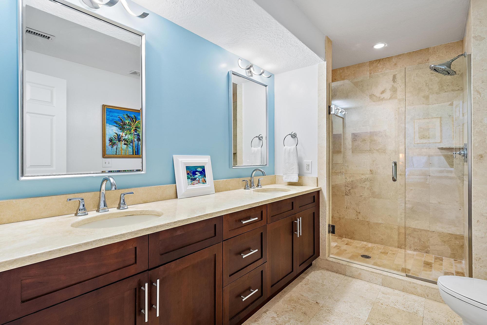 314 Inlet Way, Unit 103 Palm Beach Shores, FL 33404 - Photo 10 of 20 a bathroom with a double vanity sink mirror double and shower