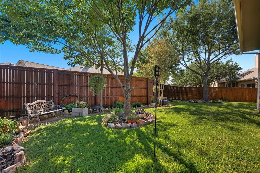 2012 Hayden Lane Corinth, TX 76210 - Photo 36 of 40 a backyard of a house with table and chairs