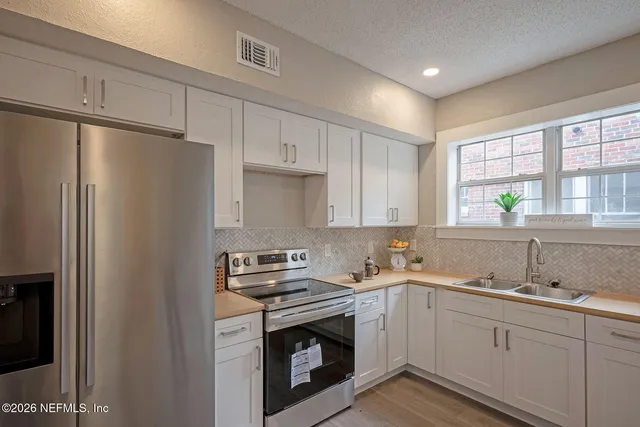 a kitchen with a sink stove and refrigerator