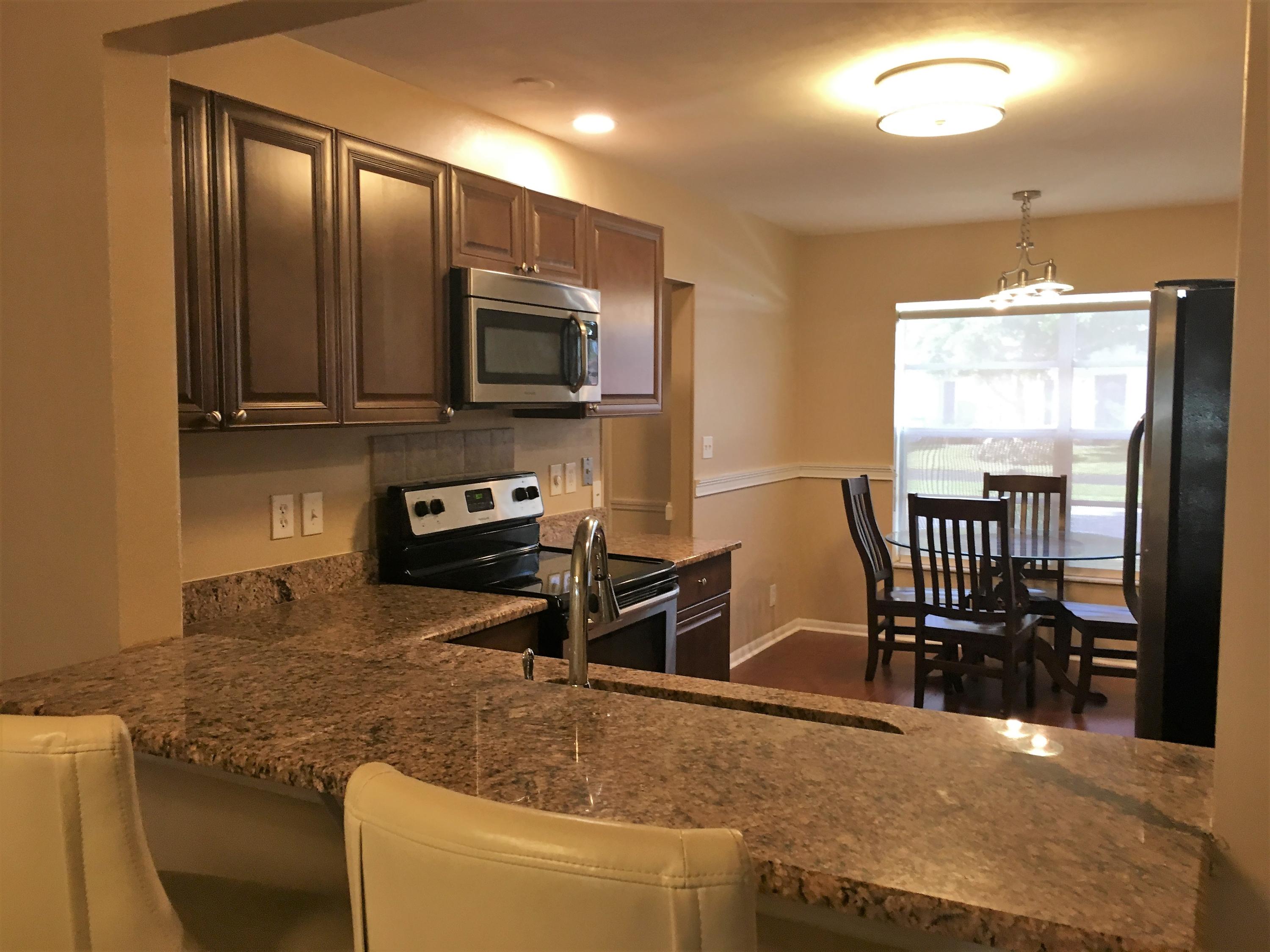 7200 Pine Manor Drive Lake Worth, FL 33467 - Photo 4 of 48 kitchen bar with chairs