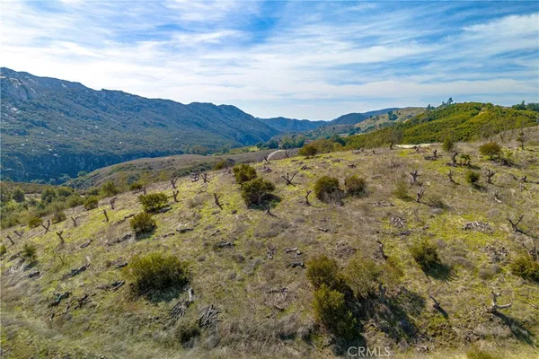 a view of a large building with mountains in the background