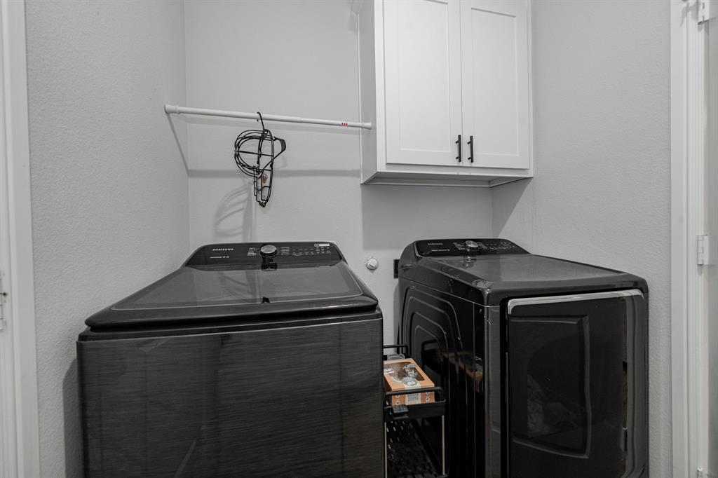 248 Waters Rdg Drive Lavon, TX 75166 - Photo 15 of 36 Laundry room featuring a textured wall, cabinet space, and independent washer and dryer