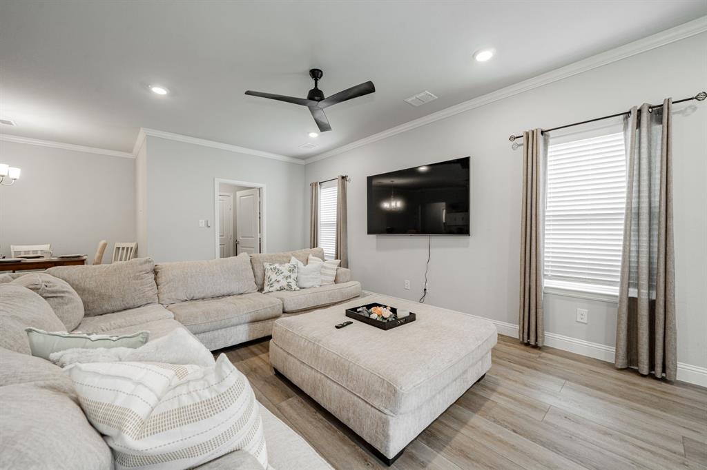 248 Waters Rdg Drive Lavon, TX 75166 - Photo 18 of 36 Living room with light wood-style floors, a ceiling fan, crown molding, and recessed lighting