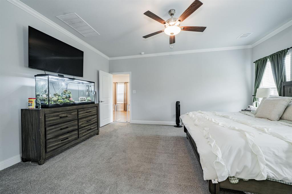 248 Waters Rdg Drive Lavon, TX 75166 - Photo 22 of 36 Bedroom featuring ornamental molding, ceiling fan, and light colored carpet