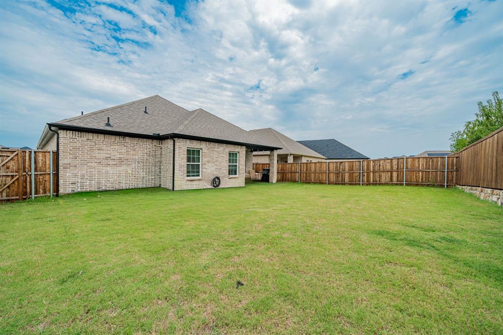 248 Waters Rdg Drive Lavon, TX 75166 - Photo 33 of 36 Back of house with a fenced backyard, brick siding, roof with shingles, and a patio