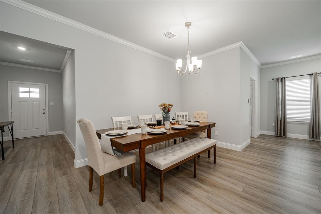 248 Waters Rdg Drive Lavon, TX 75166 - Photo 4 of 36 Dining room with crown molding, light wood-type flooring, and suspended lighting