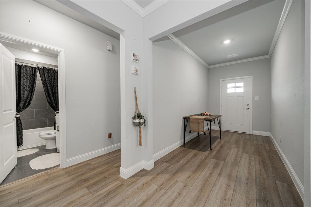 248 Waters Rdg Drive Lavon, TX 75166 - Photo 5 of 36 Foyer with crown molding and light wood-type flooring
