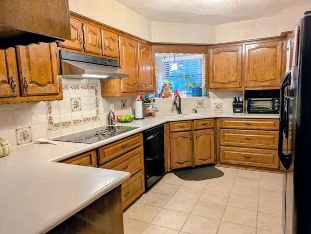 a kitchen with a sink stove and cabinets