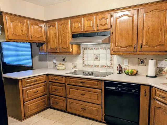 a kitchen with granite countertop cabinets and window