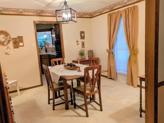 a view of a dining room with furniture and a window