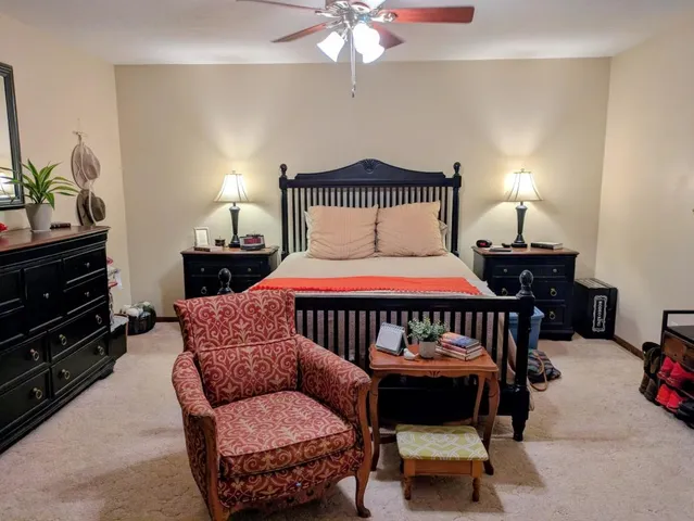 a bedroom with a bed and a chandelier