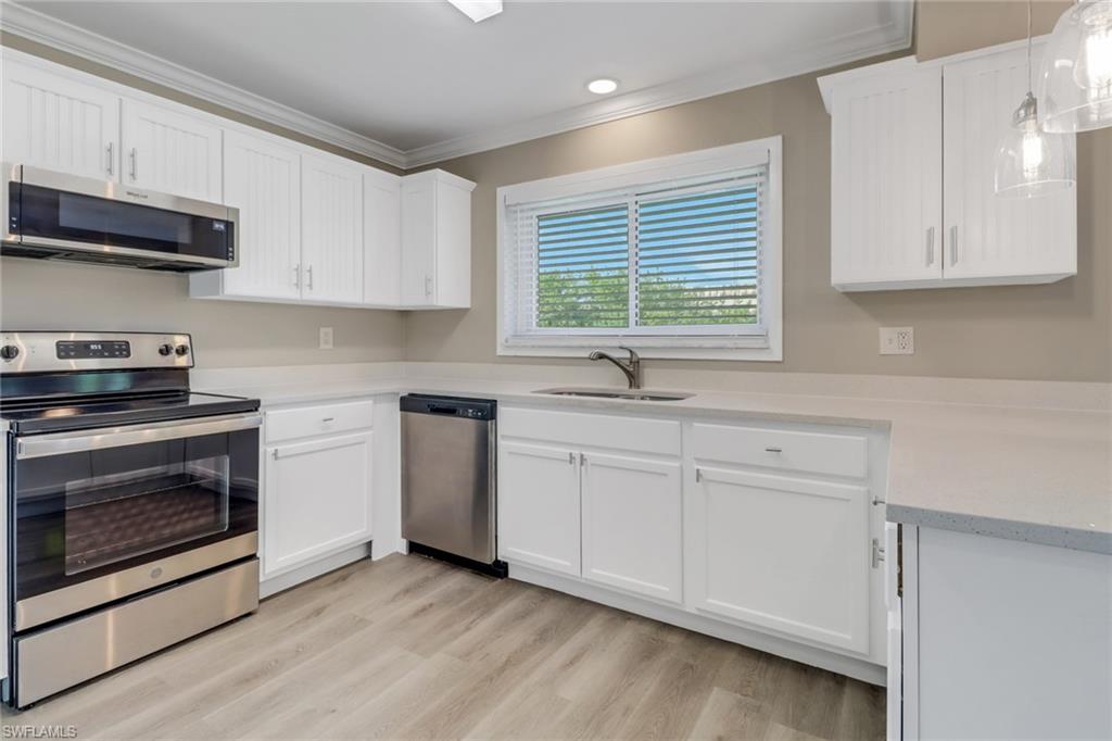 4599 Mongite Road North Port, FL 34287 - Photo 11 of 28 a kitchen with stainless steel appliances a stove a sink and a microwave