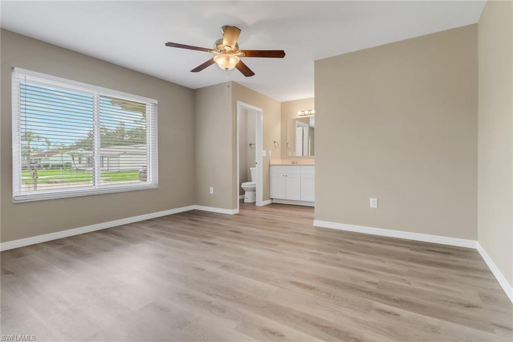 4599 Mongite Road North Port, FL 34287 - Photo 12 of 28 a view of an empty room with a window and wooden floor
