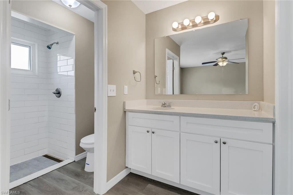 4599 Mongite Road North Port, FL 34287 - Photo 14 of 28 a bathroom with a double vanity sink a mirror and a shower