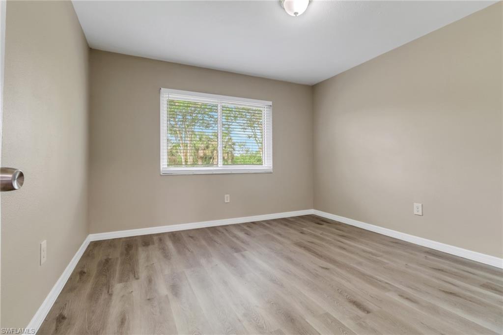 4599 Mongite Road North Port, FL 34287 - Photo 16 of 28 an empty room with wooden floor and windows