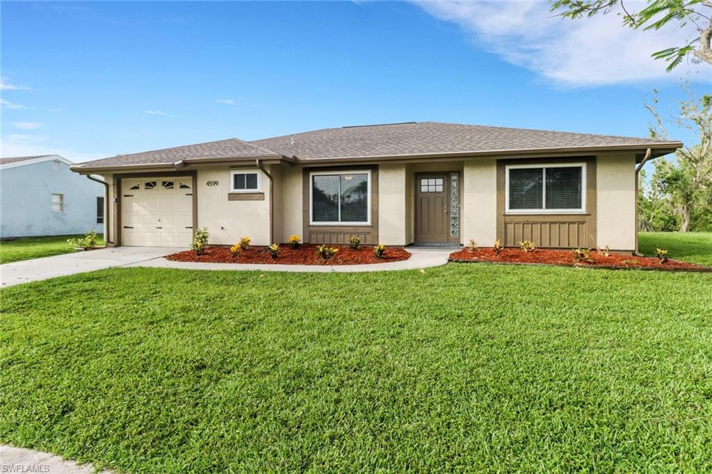 4599 Mongite Road North Port, FL 34287 - Photo 2 of 28 a front view of house with yard and green space