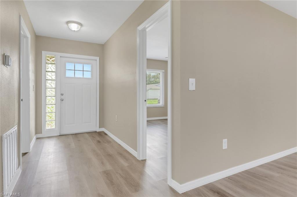 4599 Mongite Road North Port, FL 34287 - Photo 3 of 28 wooden floor in a hall with an entryway