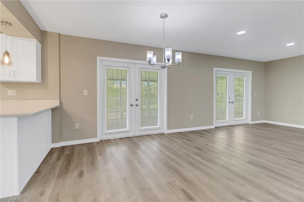 4599 Mongite Road North Port, FL 34287 - Photo 7 of 28 an empty room with wooden floor and windows