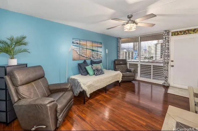 a living room with furniture and a wooden floor