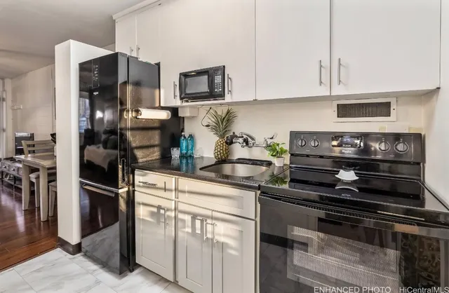 a kitchen with cabinets and stainless steel appliances