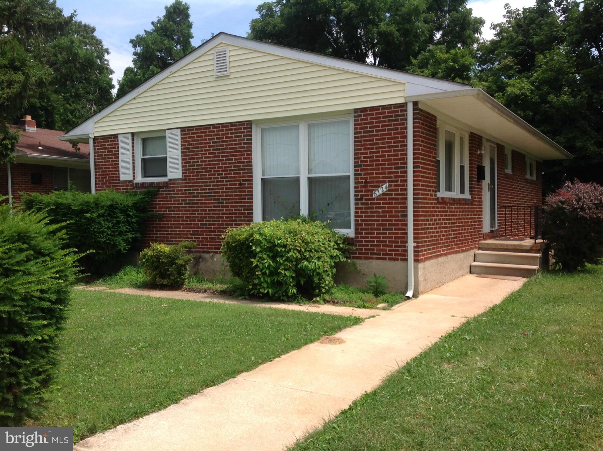 6724 Campfield Road Baltimore, MD 21207 - Photo 1 of 6 a front view of a house with a yard