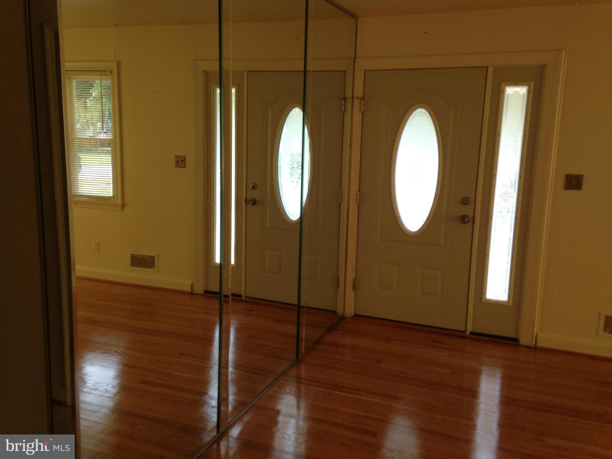 6724 Campfield Road Baltimore, MD 21207 - Photo 2 of 6 a bathroom with a mirror and a shower
