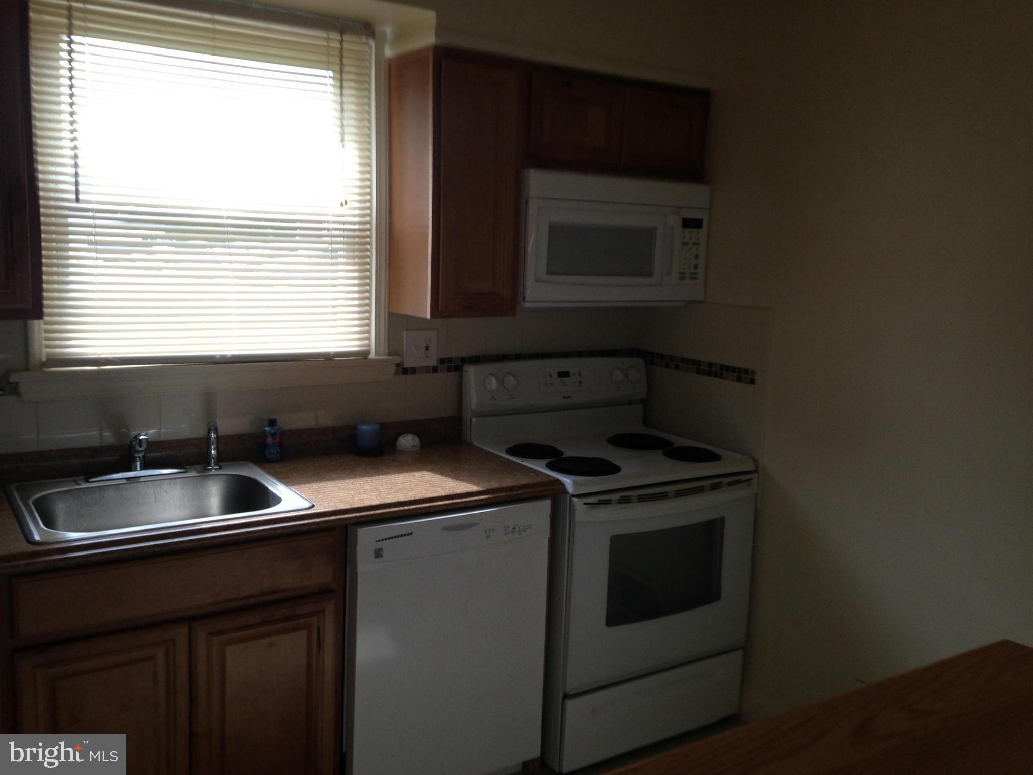 6724 Campfield Road Baltimore, MD 21207 - Photo 3 of 6 a kitchen with a stove and a sink