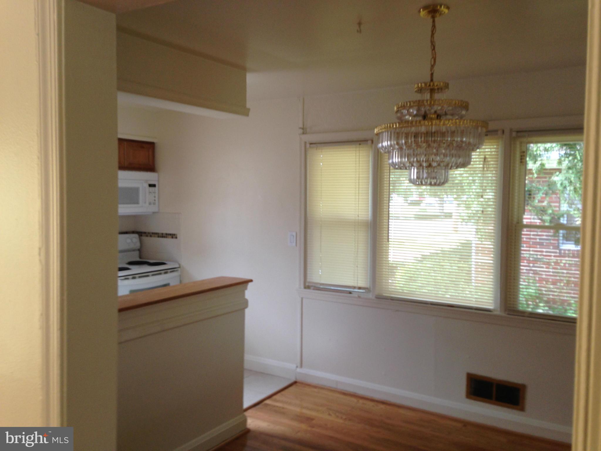 6724 Campfield Road Baltimore, MD 21207 - Photo 6 of 6 a kitchen with a wooden floor and a window