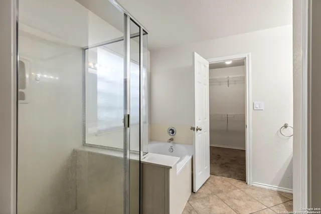 a bathroom with a glass shower door