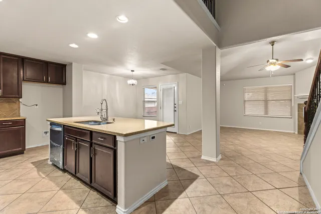 a kitchen with kitchen island a sink stove and refrigerator
