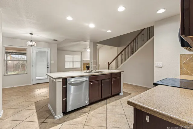 a kitchen with stainless steel appliances granite countertop a sink and a stove