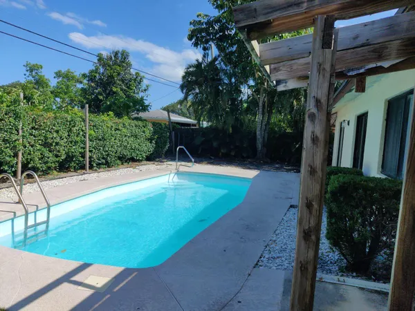 a view of a swimming pool with an outdoor seating