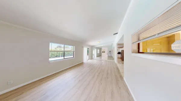 a view of a living room hardwood floor and a window