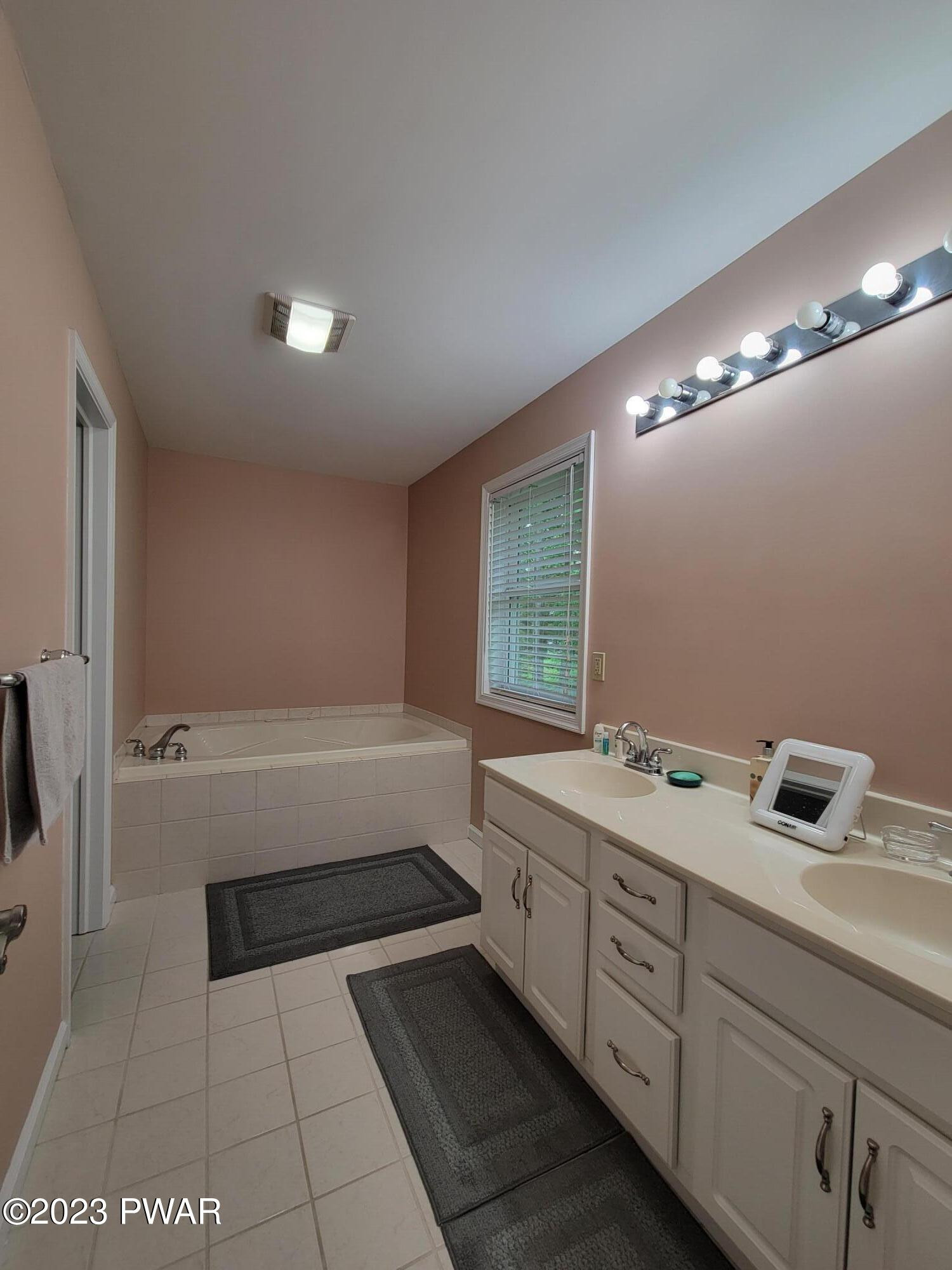 110 Rodeo Lane Hawley, PA 18428 - Photo 25 of 36 a bathroom with a tub sink and mirror