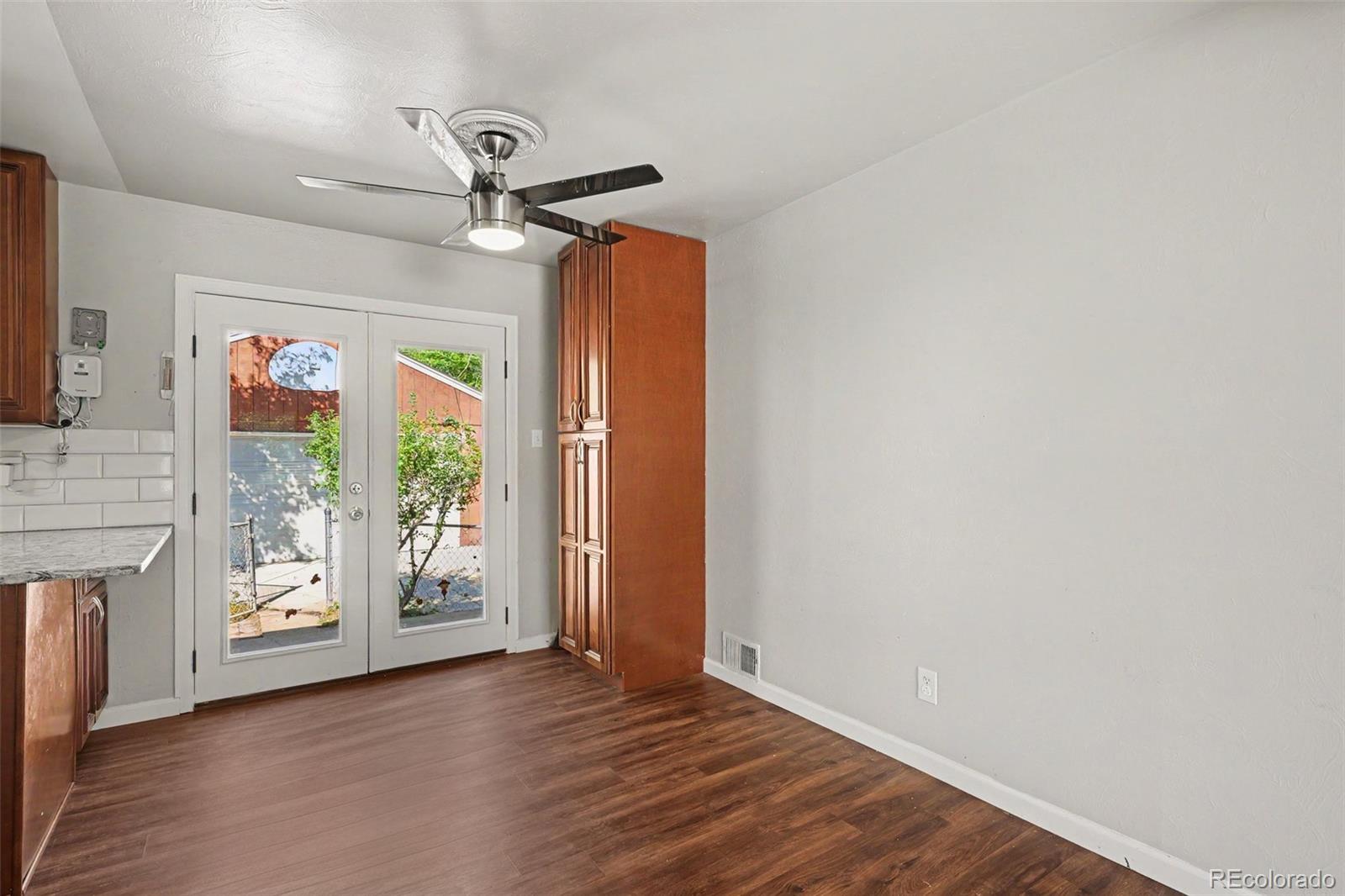 3217 South Stuart Street Denver, CO 80236 - Photo 12 of 29 a view of livingroom with hardwood floor and a ceiling fan