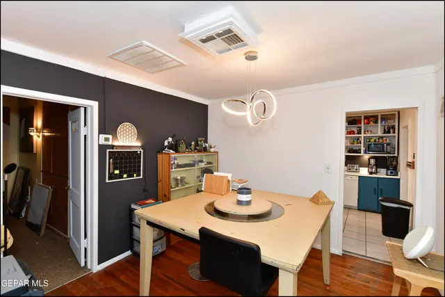 a room with a workspace and a bookshelf