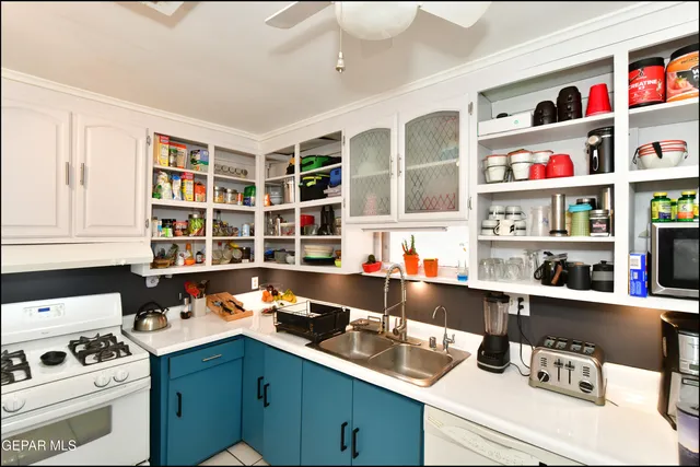 a room with a workspace and a bookshelf