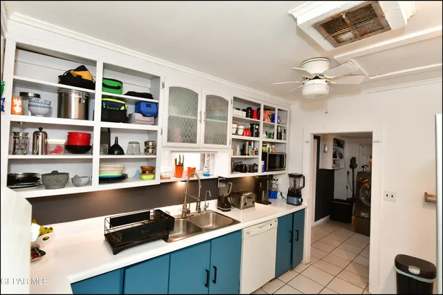 a kitchen counter with a sink and wooden floor