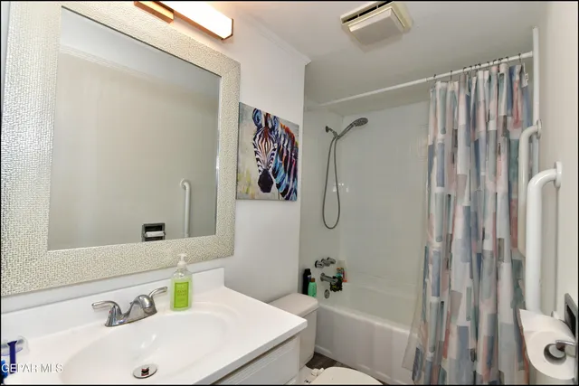 a living room with furniture a couch and large windows