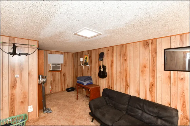 a lobby with furniture and a flat screen tv